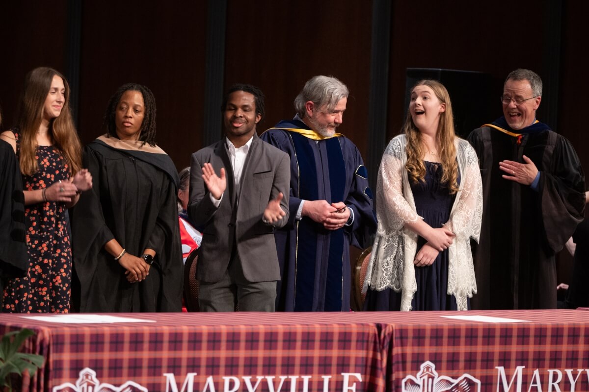 Photo of Jewell West reacting with astonishment after hearing her name called as the 2025 Maryville College Outstanding Senior