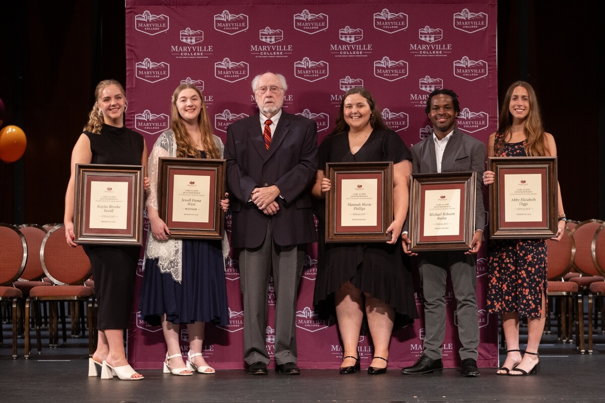 Photo of five Maryville College students and an older alumnus