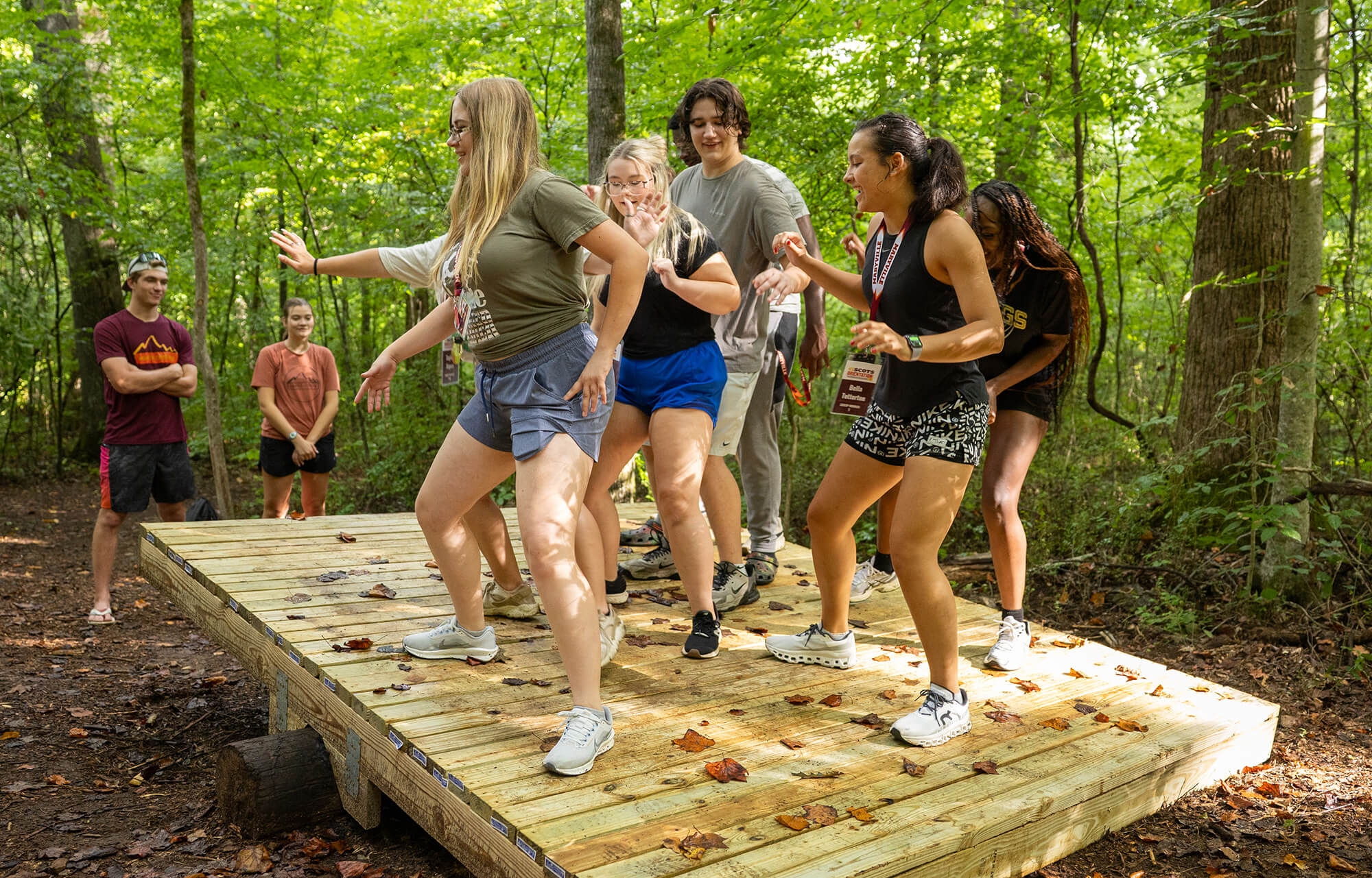 Photo of students using the low ropes course in the Maryville College Woods