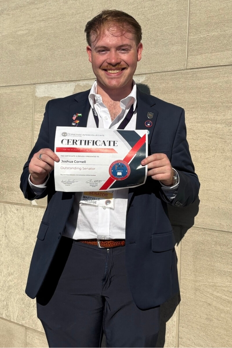 Photo of Joshua Cornell '26 with an award