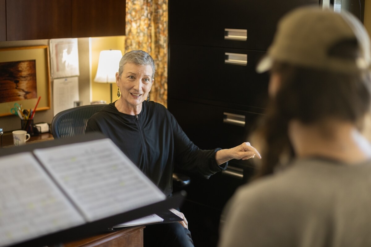 Photo of Alicia Massie-Legg working with a student before her retirement in May