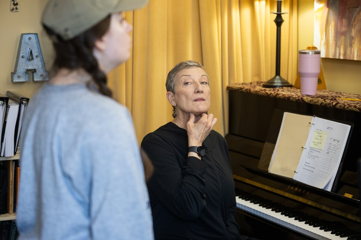 Photo of Dr. Alicia Massie-Legg indicating a proper throat method for a particular note