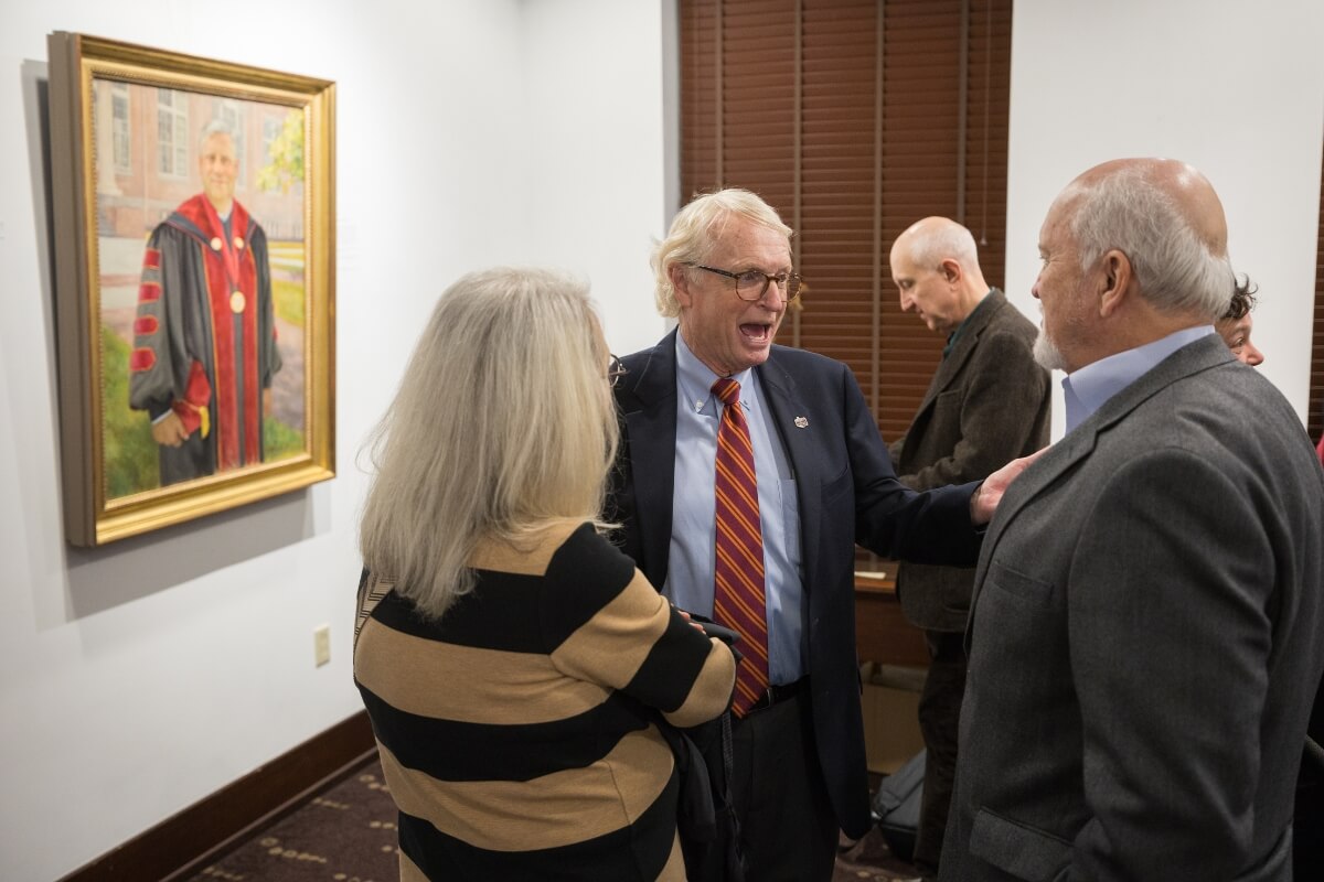 Photo of members of the Maryville College Board of Directors in front of the new portrait of President Bryan F. Coker