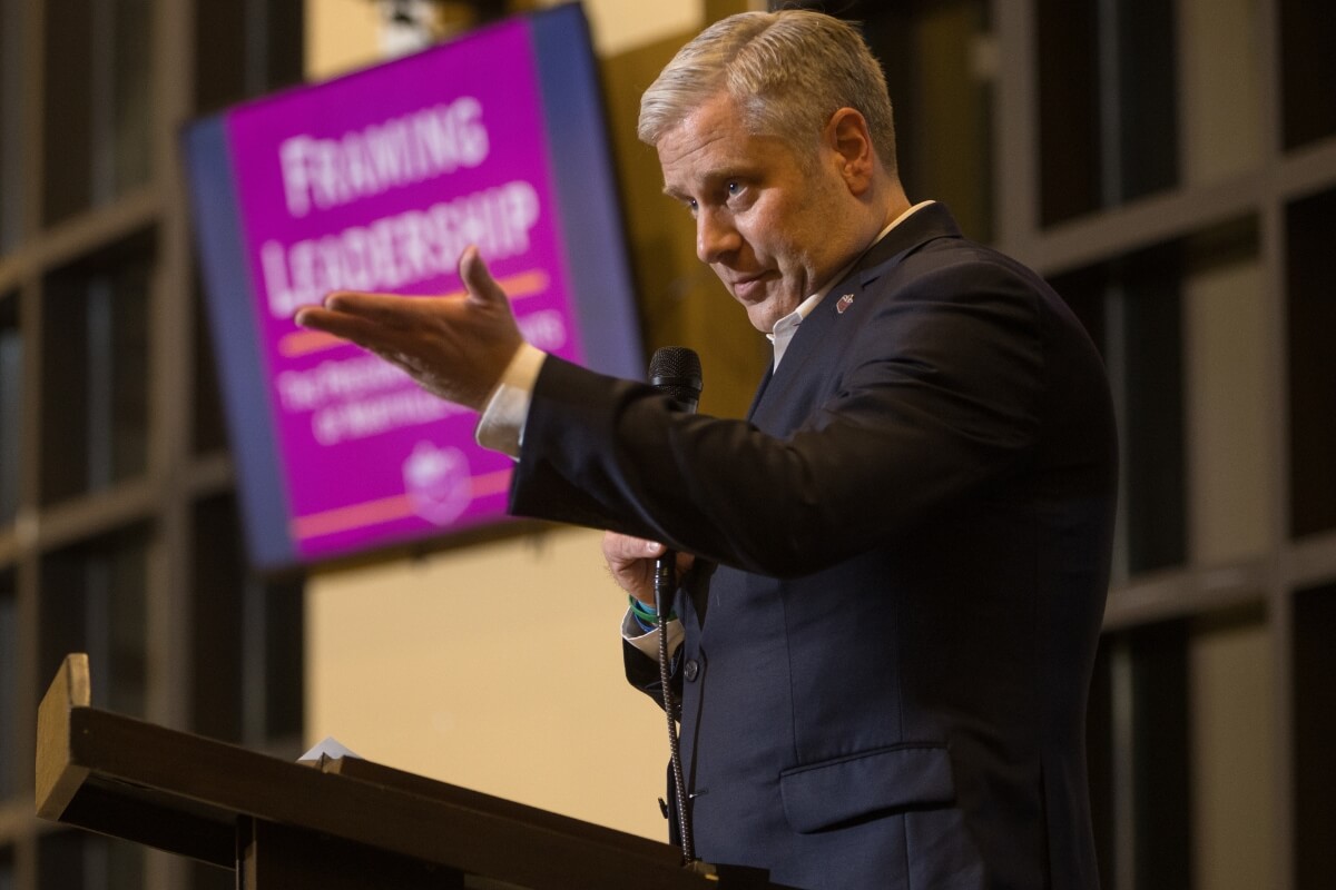 Photo of Bryan Coker gesturing to the crowd