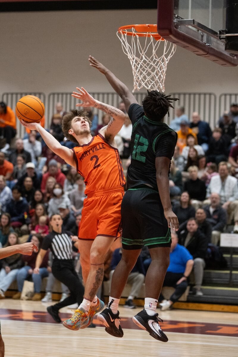 Photo of Kobe Franklin '27 going up for a basket during a basketball game