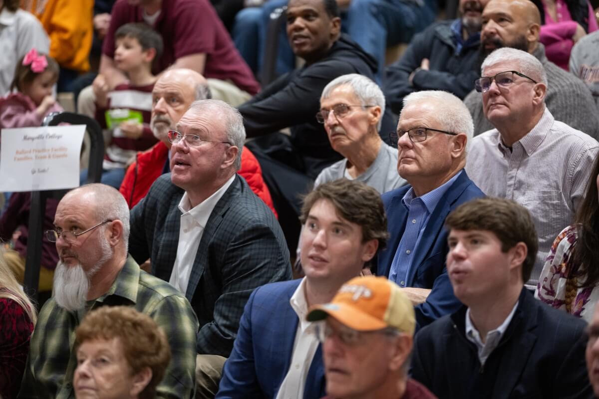 Photo of a crowd of people intently watching a basketball game