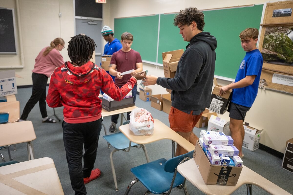 Photo of Maryville College students assembling baby and feminine hygiene kits for a community engagement project