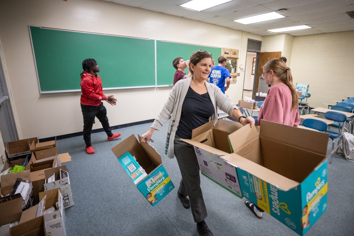 Photo of Dr. Crystal Colter carrying an empty box