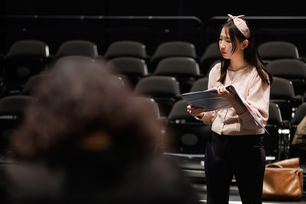 Photo of Professor Di Bei reading the script