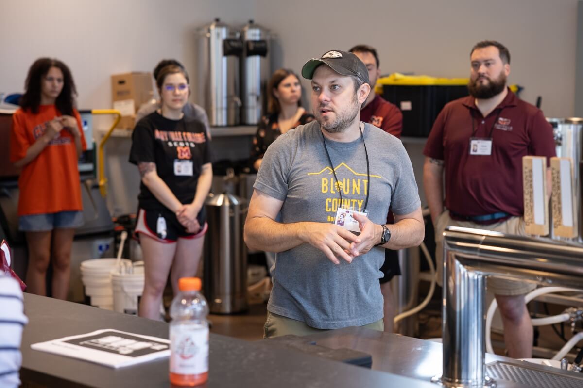Photo of alumni gathering at the MC Downtown Center to brew Maryville College beer.