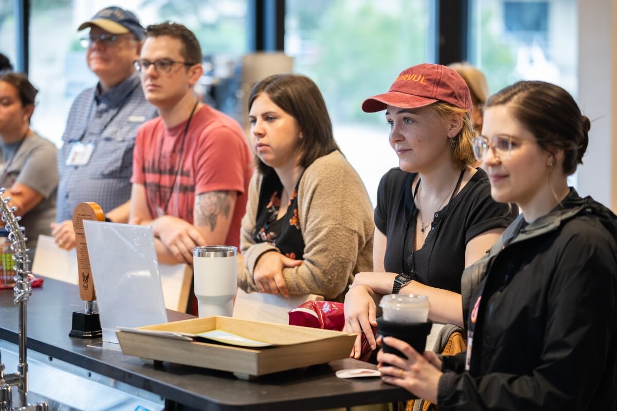 Photo of alums listening to Alumni Brewday instructions