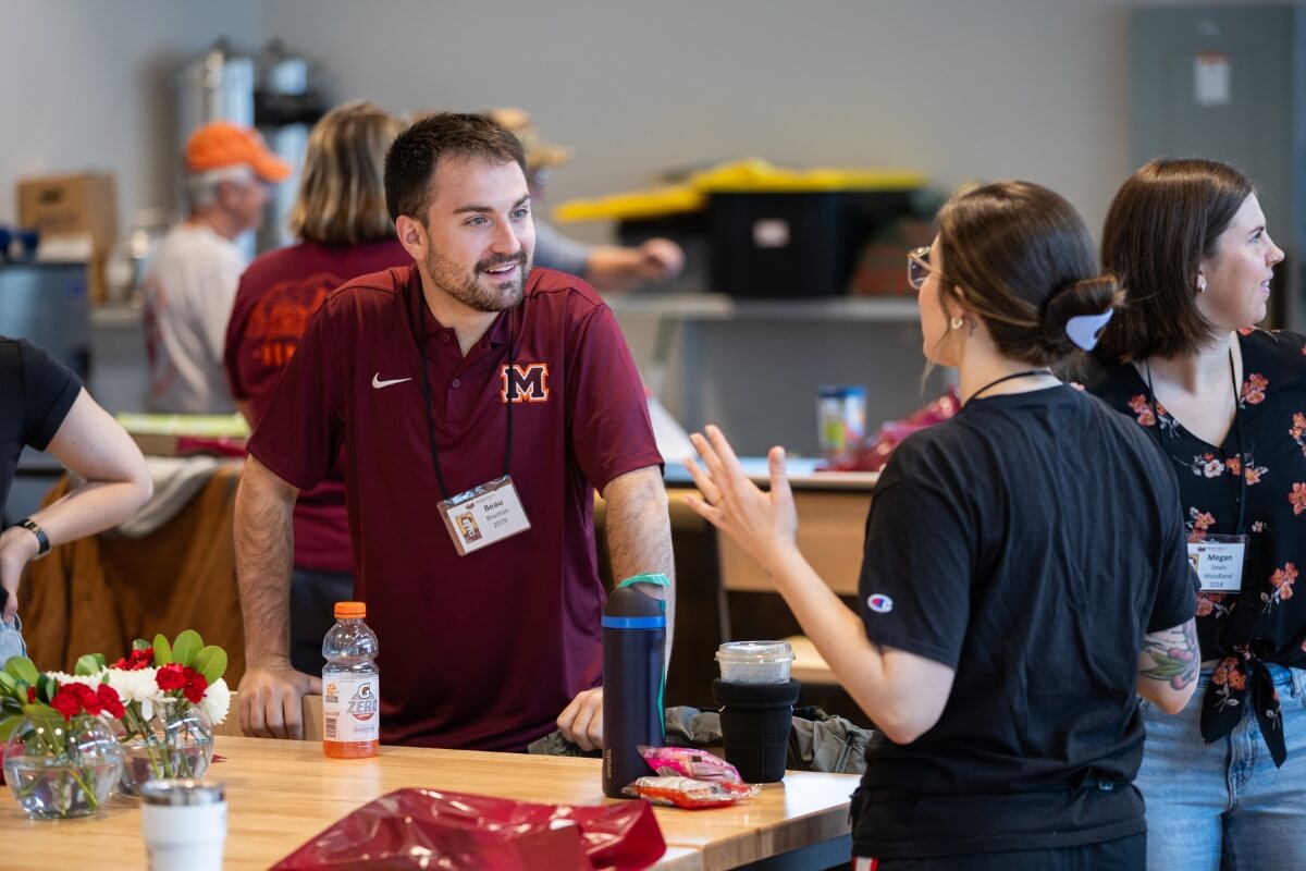 Photo of two MC alumni, talking at the Alumni Brewday