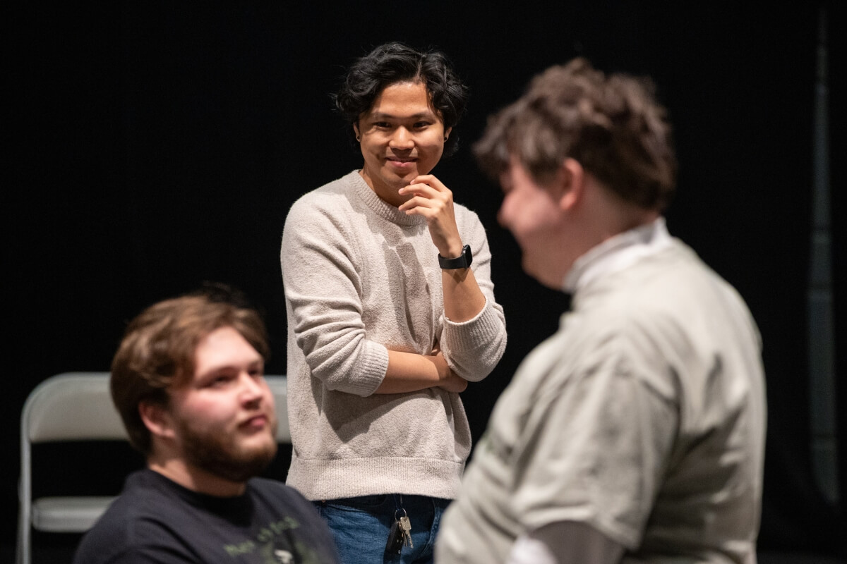 Photo of Andrew Hastings, a Maryville College senior and director of "Angels in America," watching two of his actors