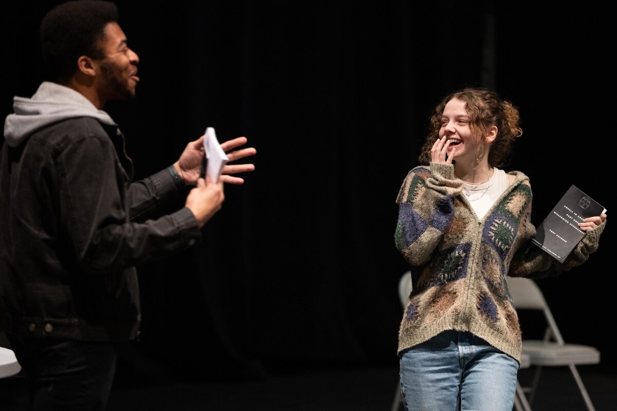 Photo of two local college students rehearsing "Angels in America"