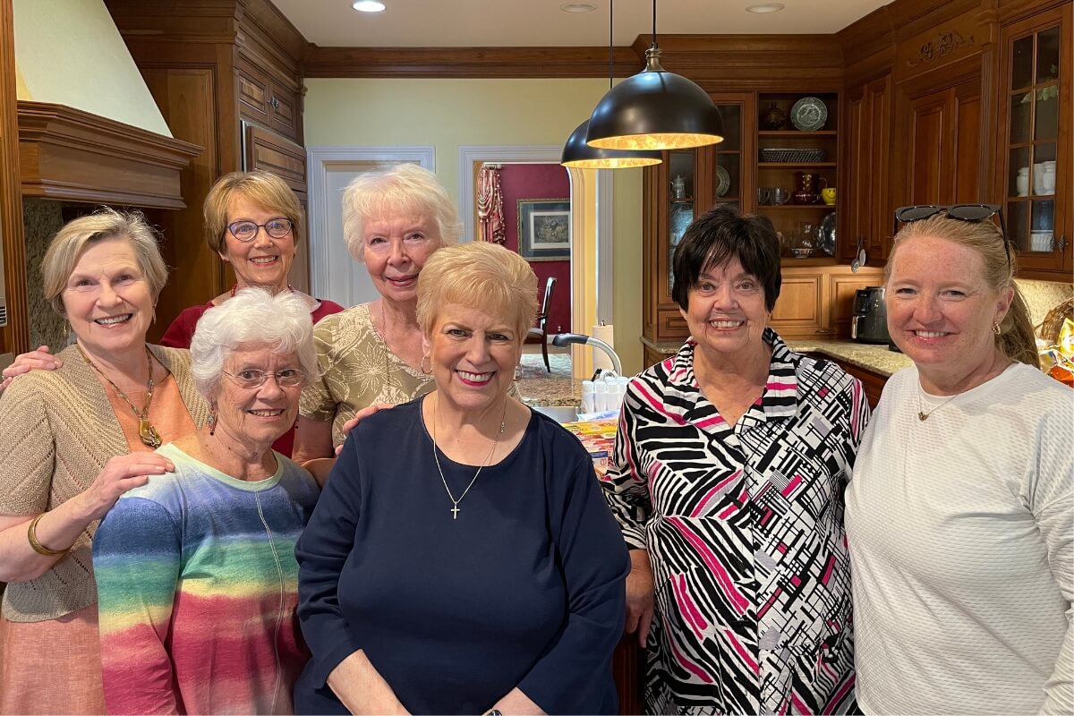 Photo of smiling participants of KT Global 2024 in a kitchen
