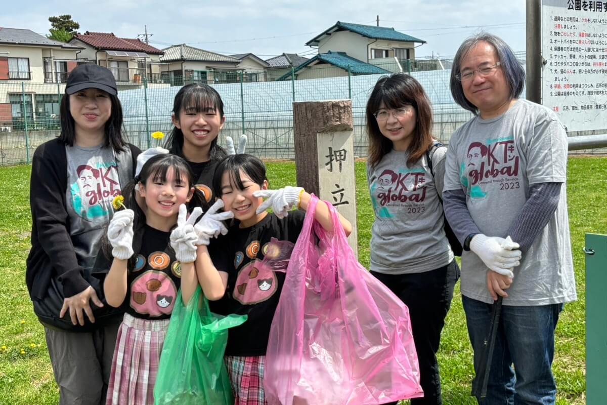 Photo of a smiling Maryville College alumnus and his family in a park in Tokyo, Japan