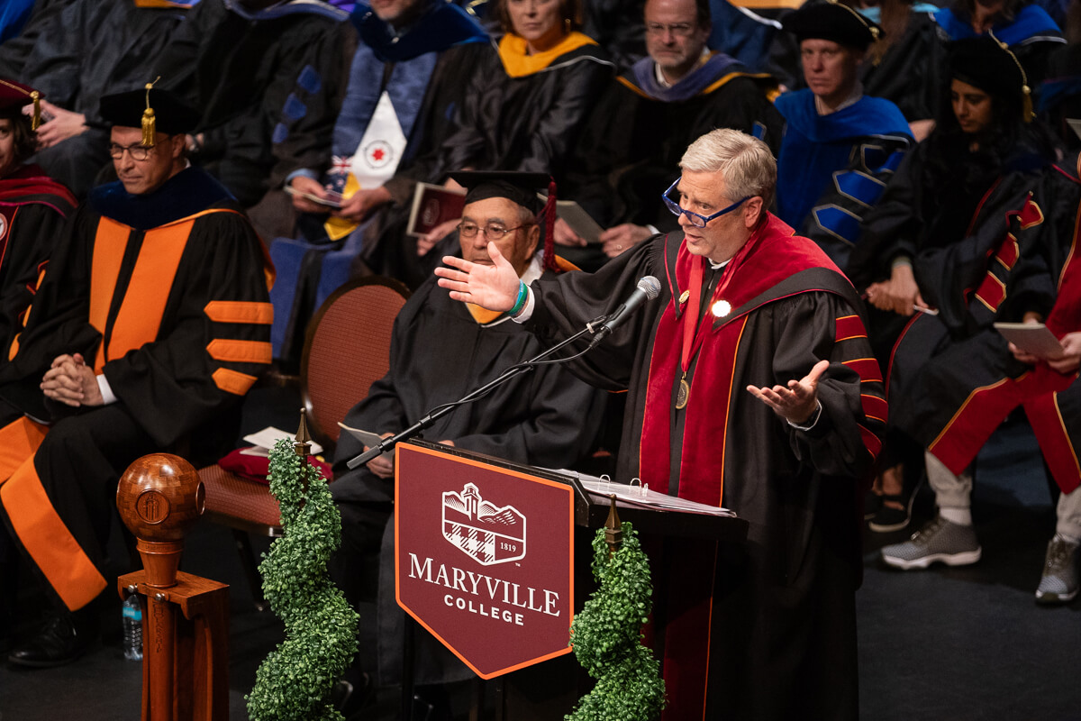Photo of Dr. Bryan F. Coker gesturing to an audience.