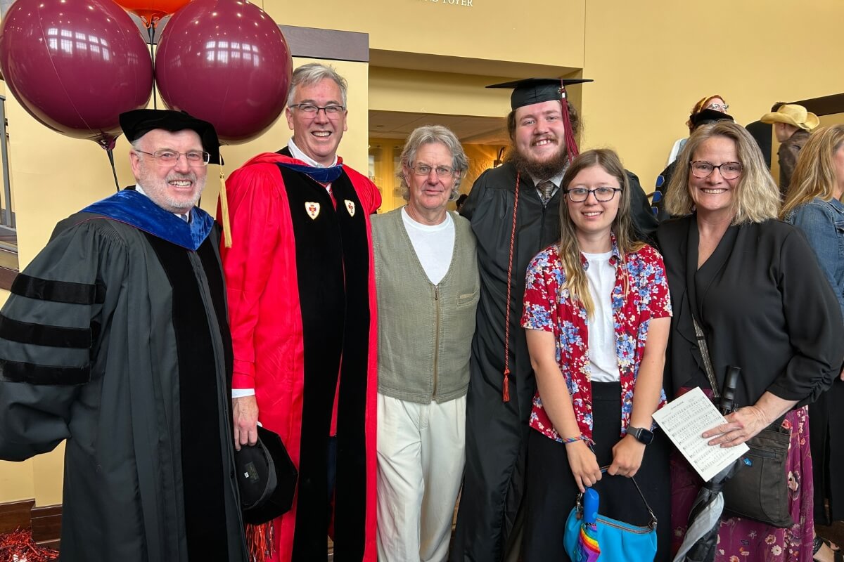 Photo of Adrian Pierce, a Maryville College graduate, with family and faculty members