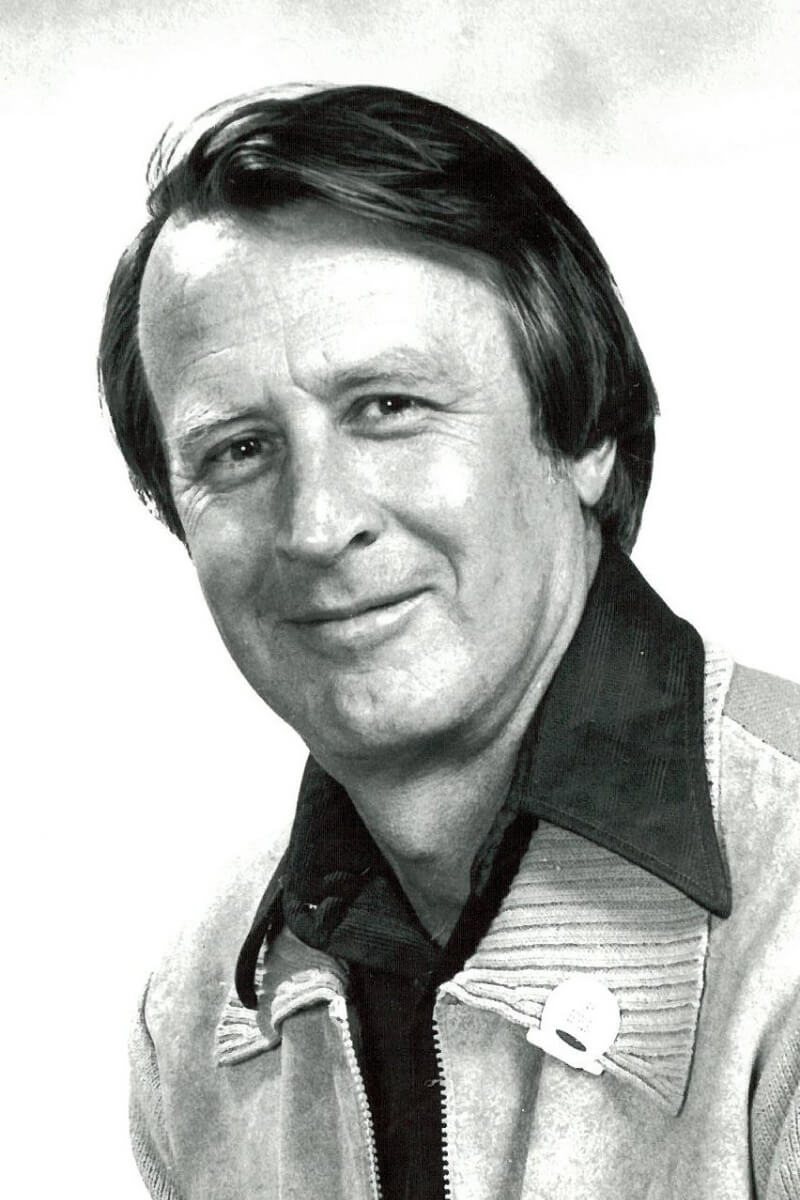 Photo of a smiling man in a 1970s-era leisure suit