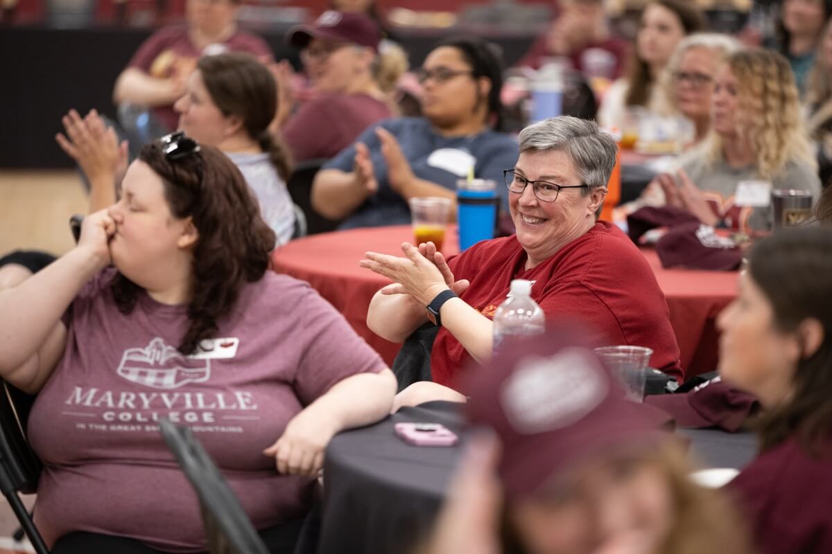Photo of Maryville College staff members seated in the Alumni Gym