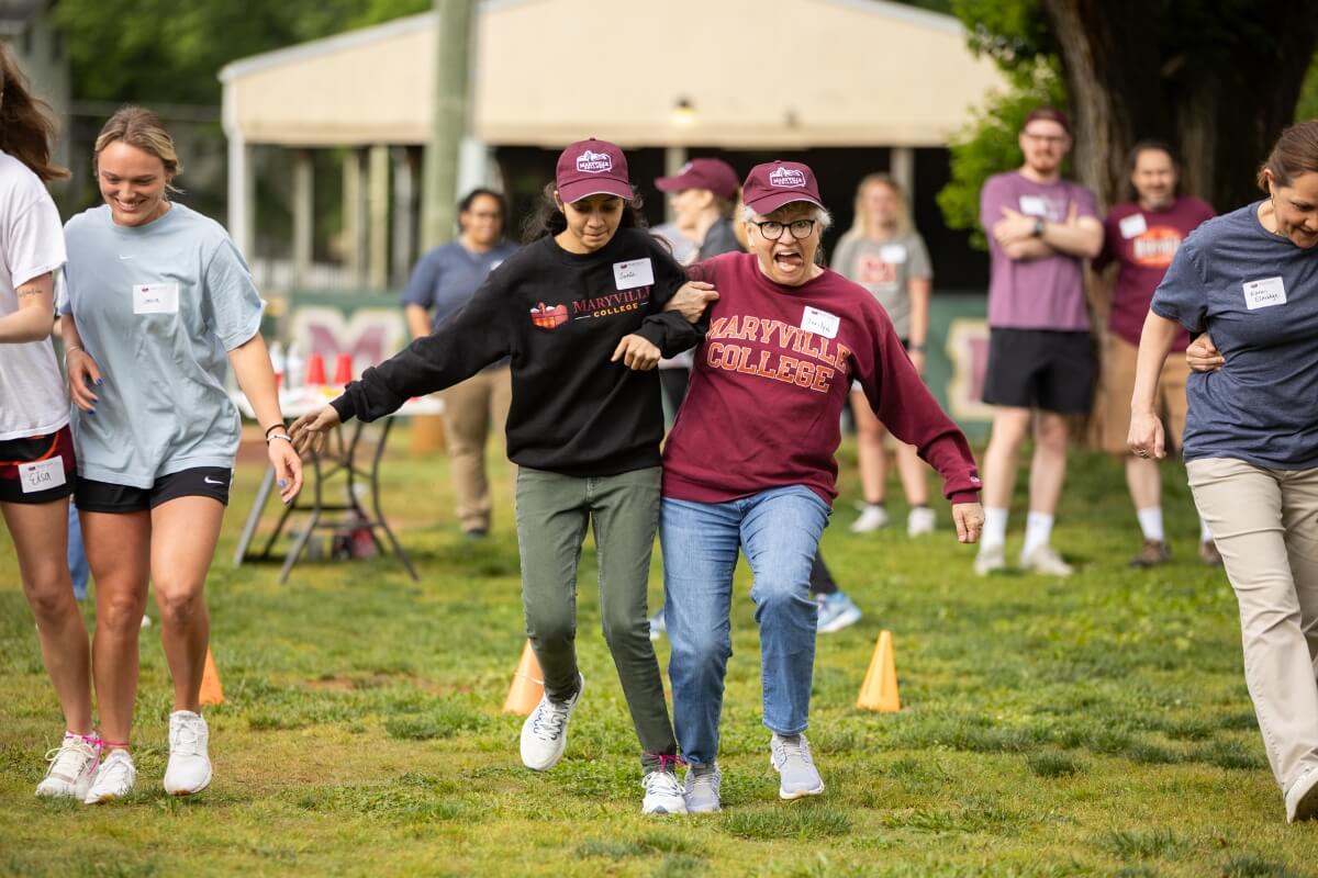 Photo of two members of Maryville College staff taking part in a three-legged race