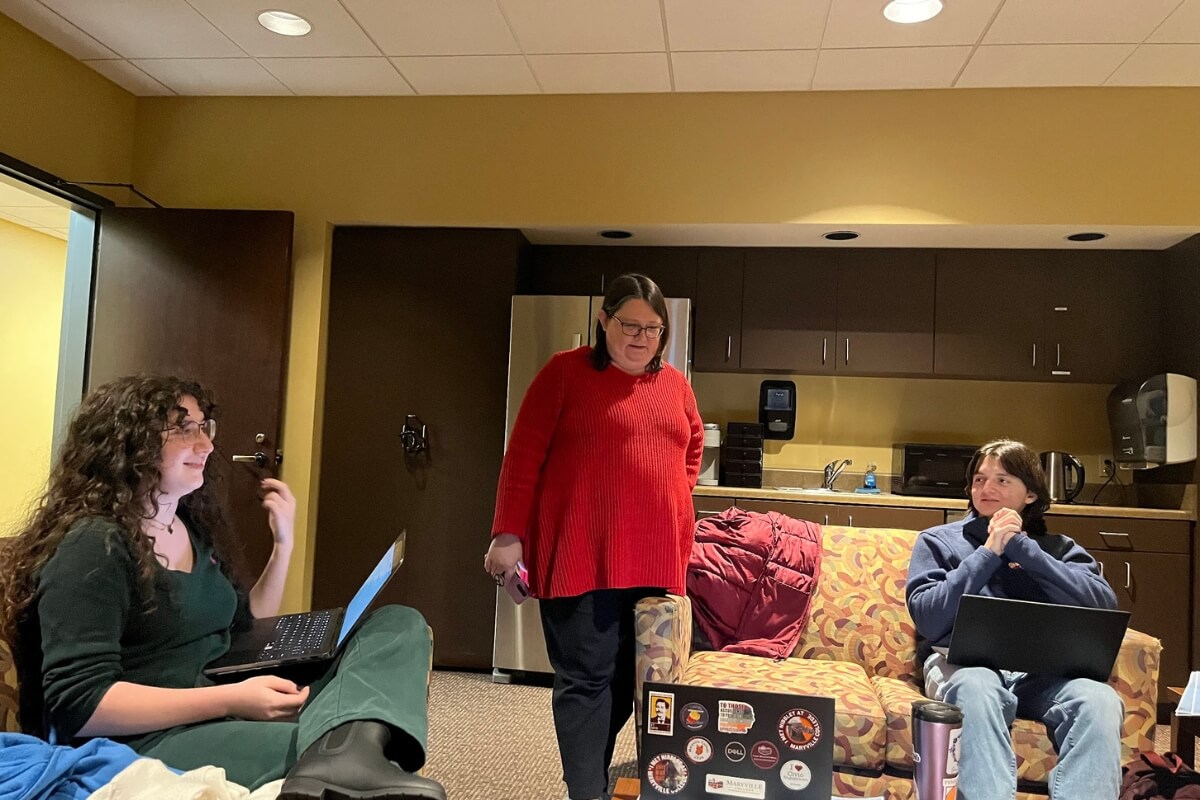 Photo of three people at Maryville College rehearsing for "Advents"