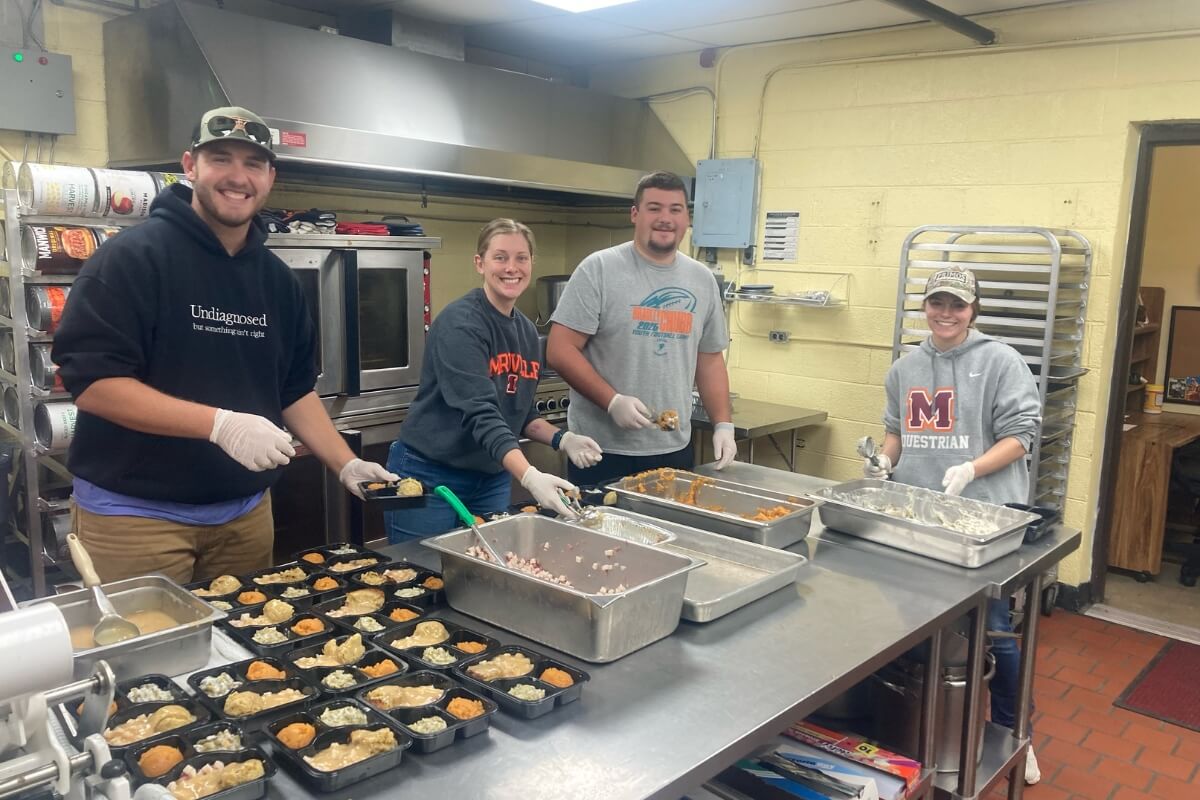 Photo of MC students in a kitchen