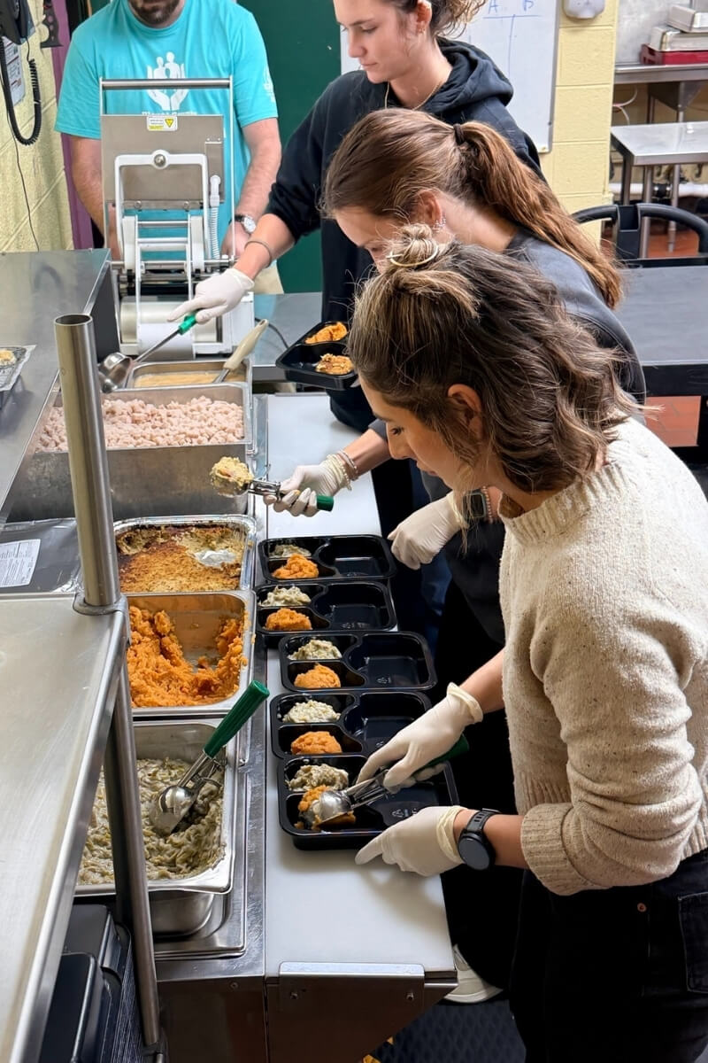 Maryville College students in a serving line, preparing food