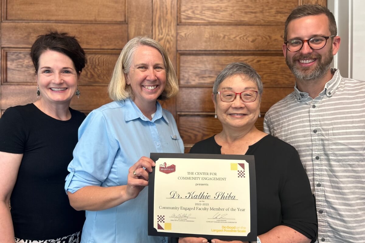 Photo Kathie Shiba receiving the Community Engaged Faculty Member of the Year Award