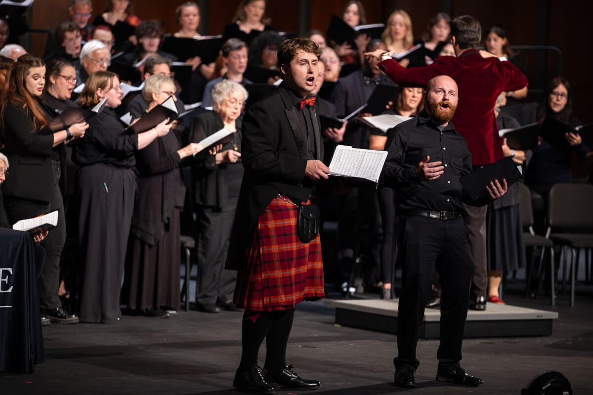 Photo of two singers on stage in mid-song