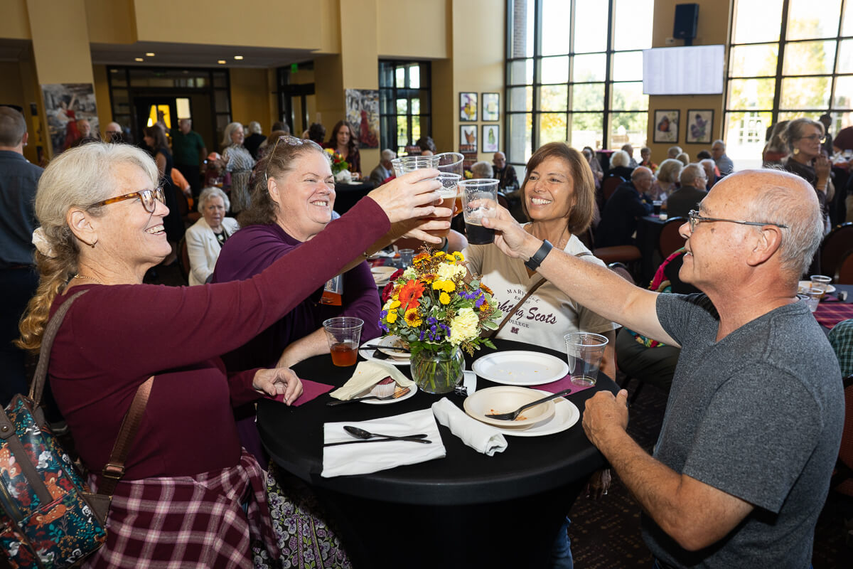 Photo of two Maryville College alumni toasting one another during Homecoming 2025 festivities