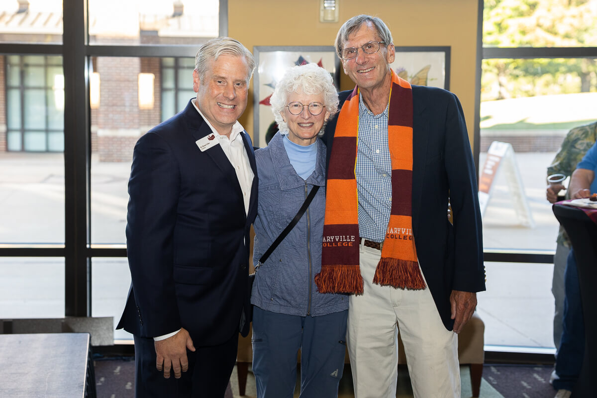 Photo of a smiling couple with President Bryan Coker during the President's Welcome Reception at Maryville College Homecoming 2025