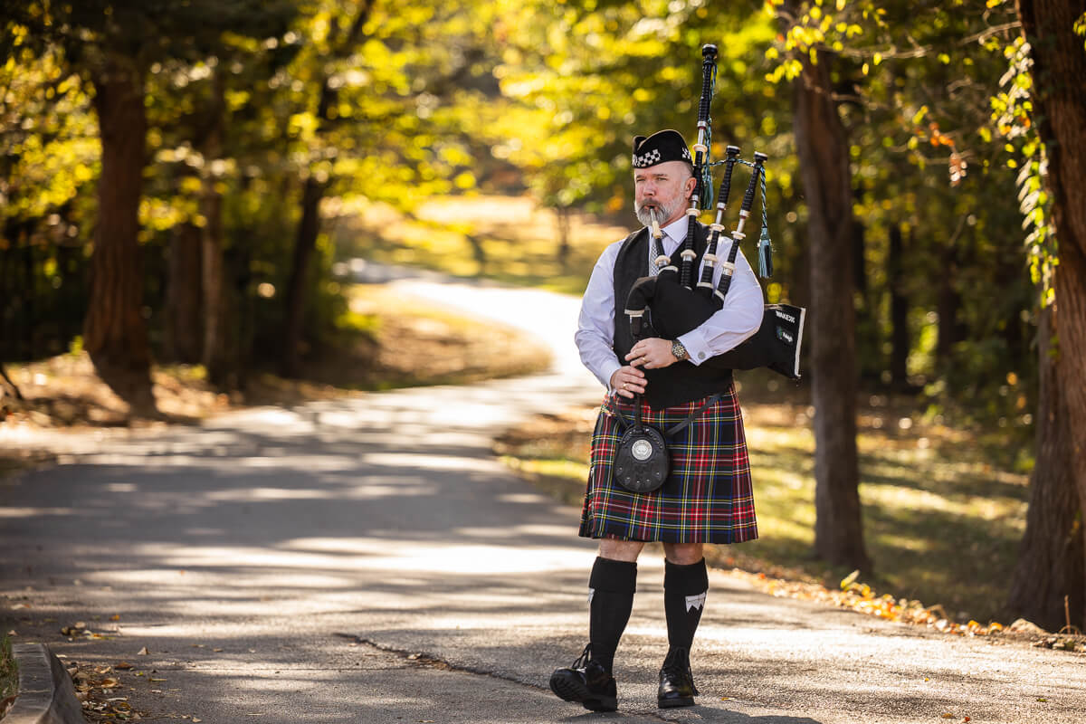 Photo of a Scottish bagpiper preparing to lead the Fighting Scots