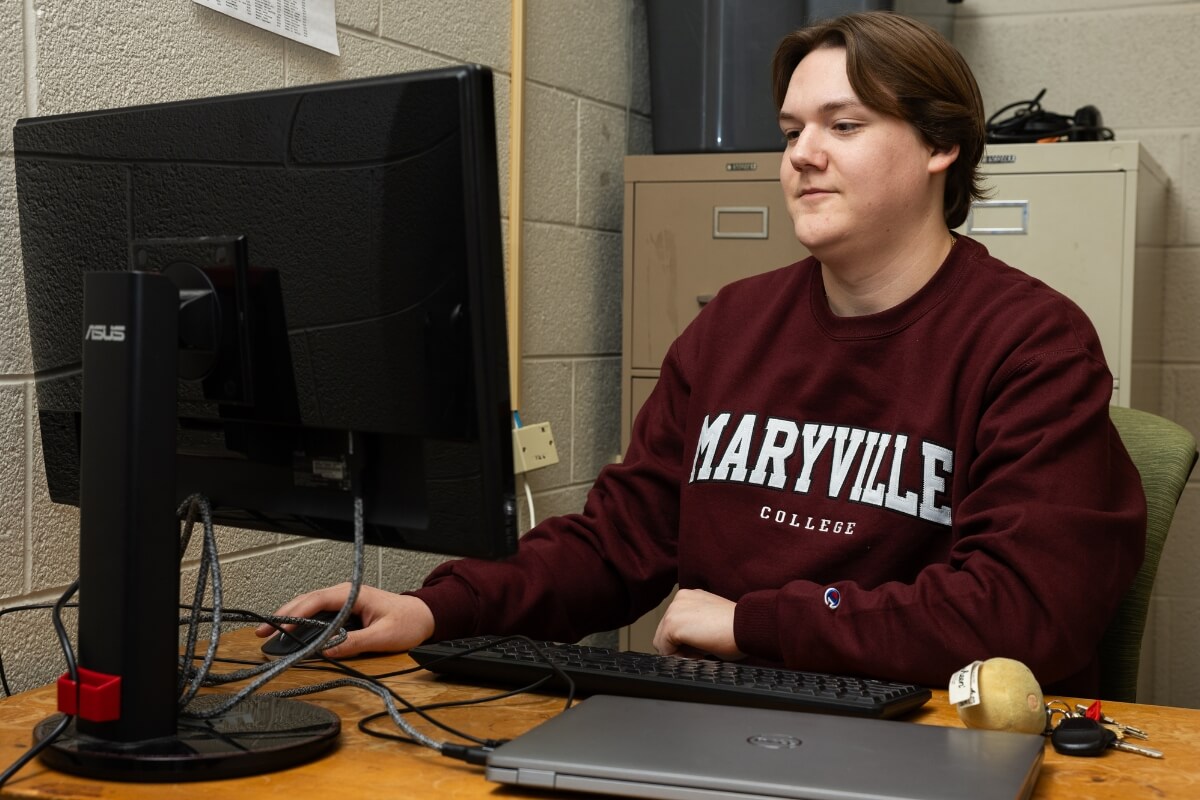 Photo of student Clayton Tuggle working on a computer