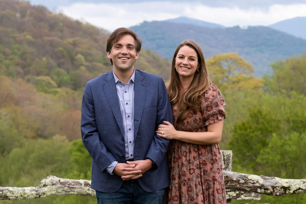 Photo of David and Annie Haslam Colquitt, smiling in front of a view of the mountains.