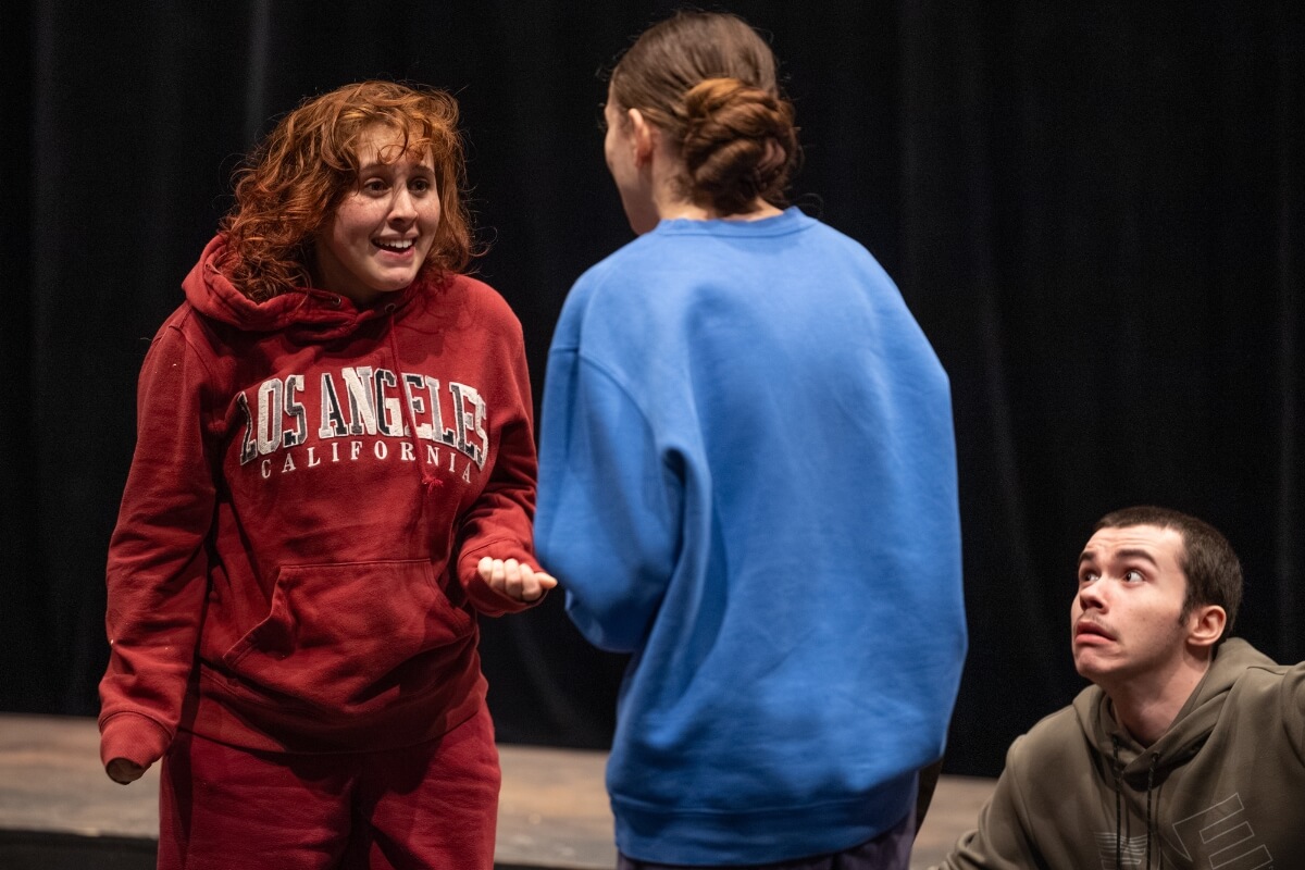 Photo of a student actor confronting another during a rehearsal scene for "The Crucible."