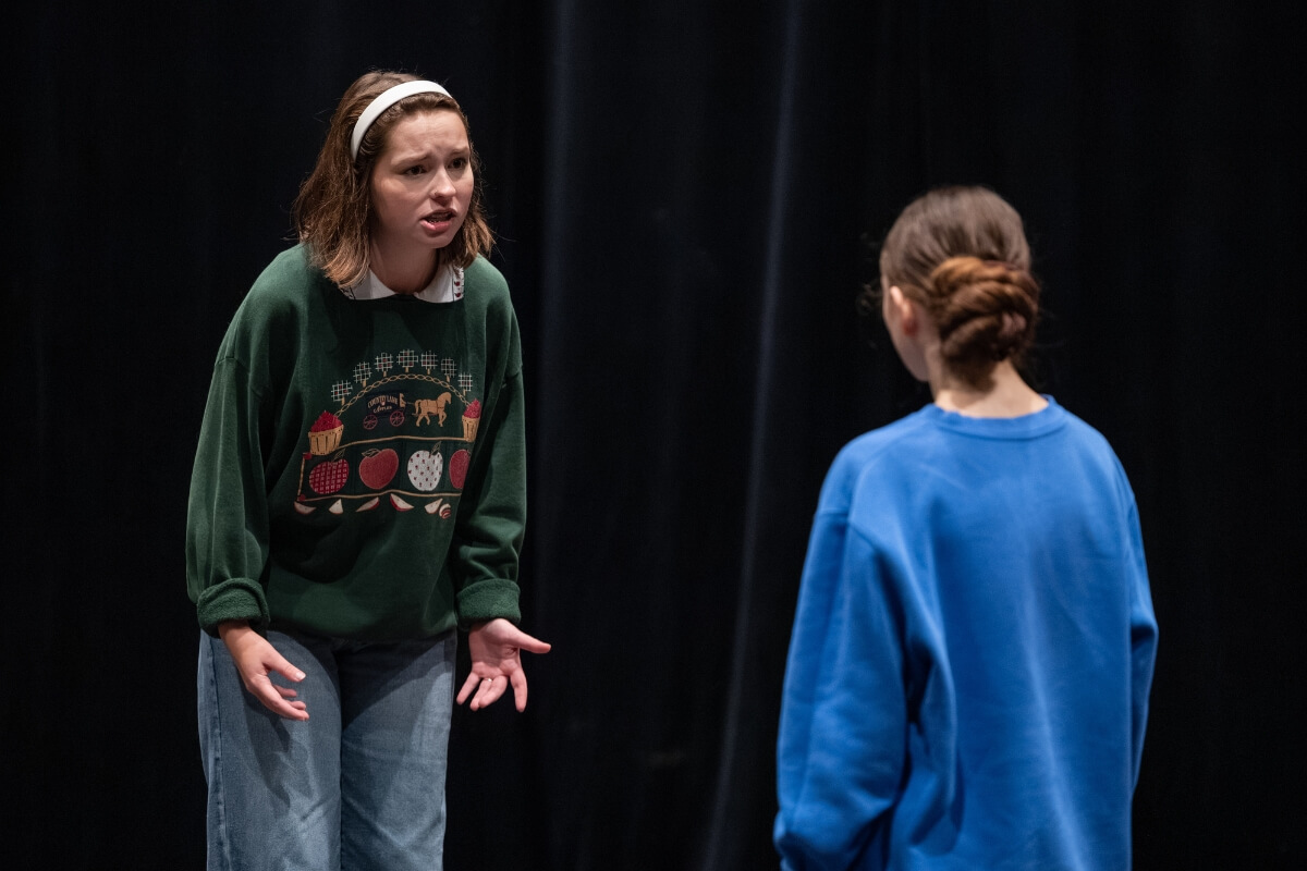 Photo of two students rehearsing a scene from "The Crucible"