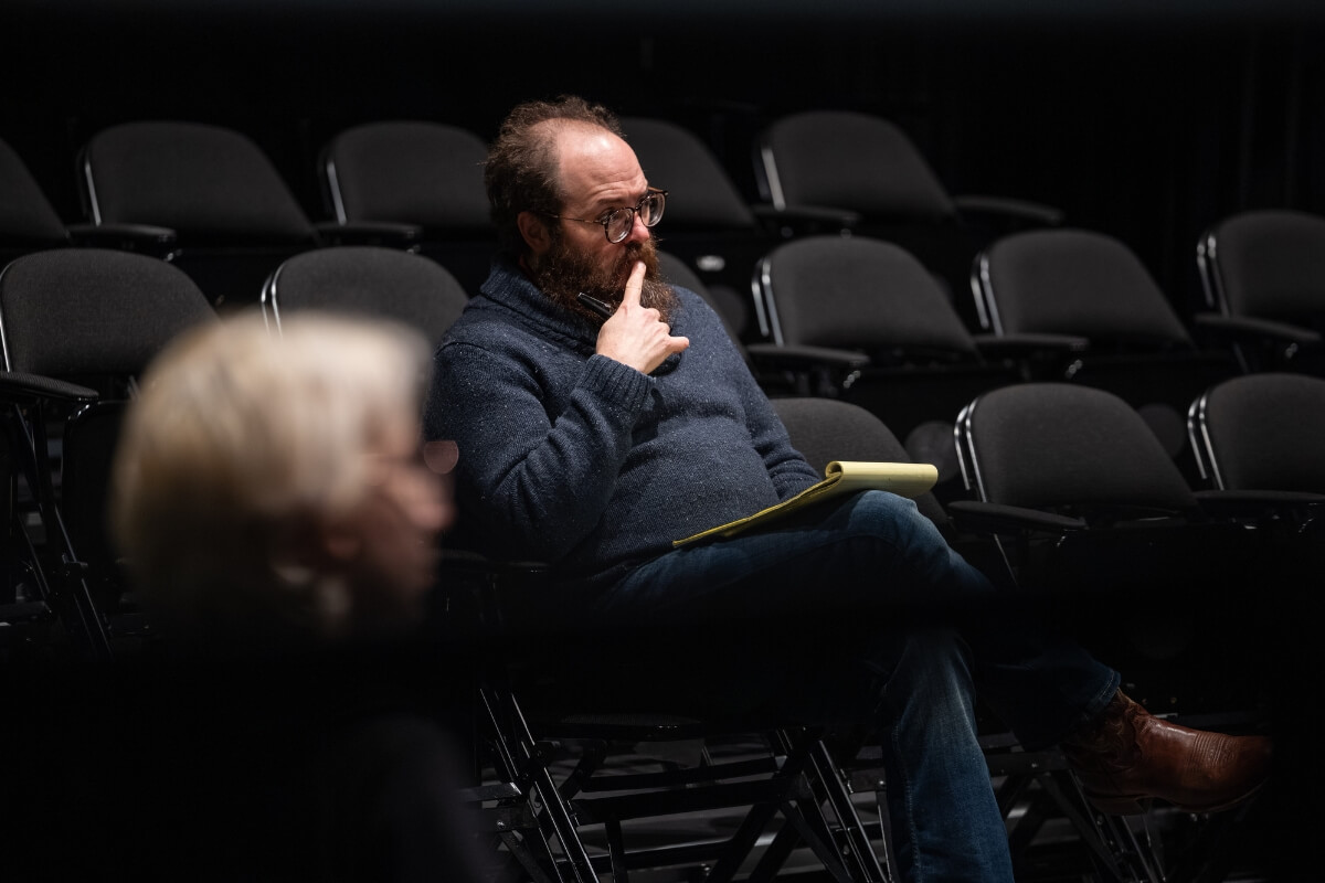 Photo of Maryville College Assistant Professor of Theatre Andy Vaught, watching a rehearsal of "The Crucible"