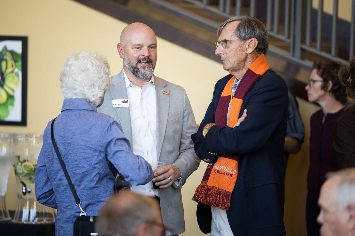 Photo of the Postlers talking to Ben Stubbs