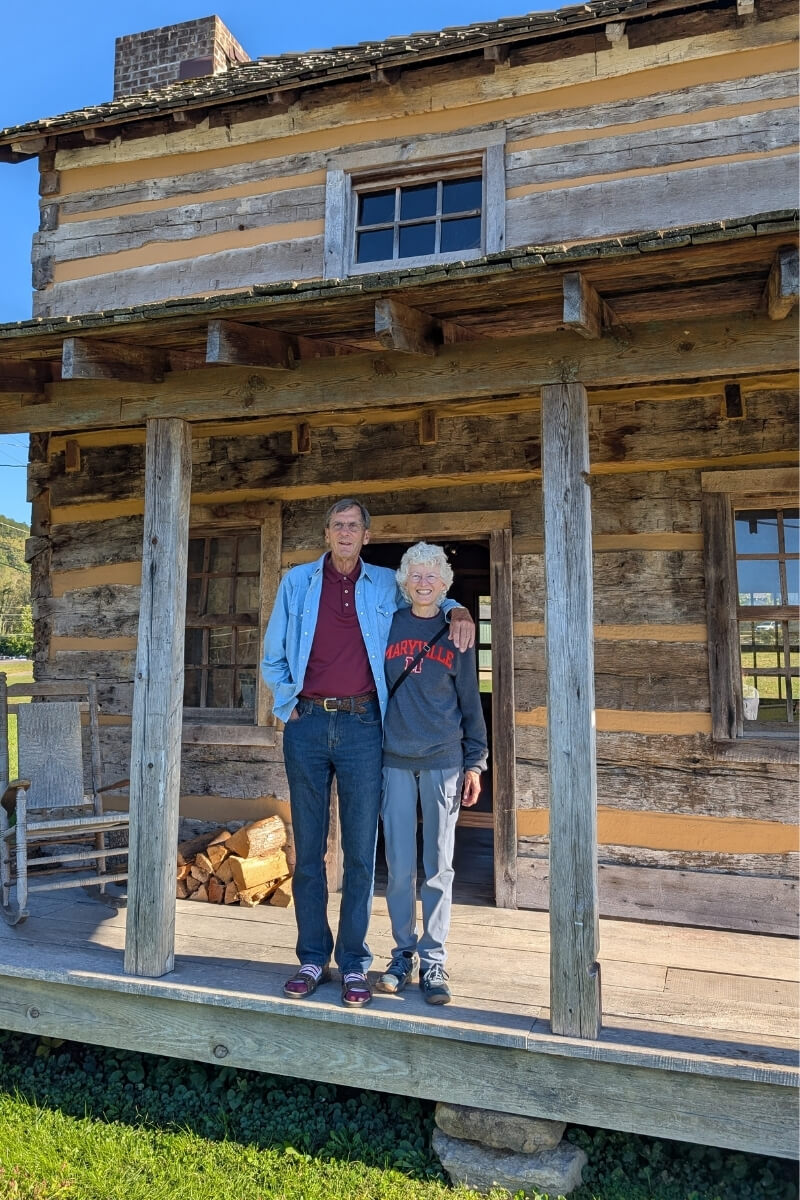 Photo of the Postlers standing on the porch of an old cabin