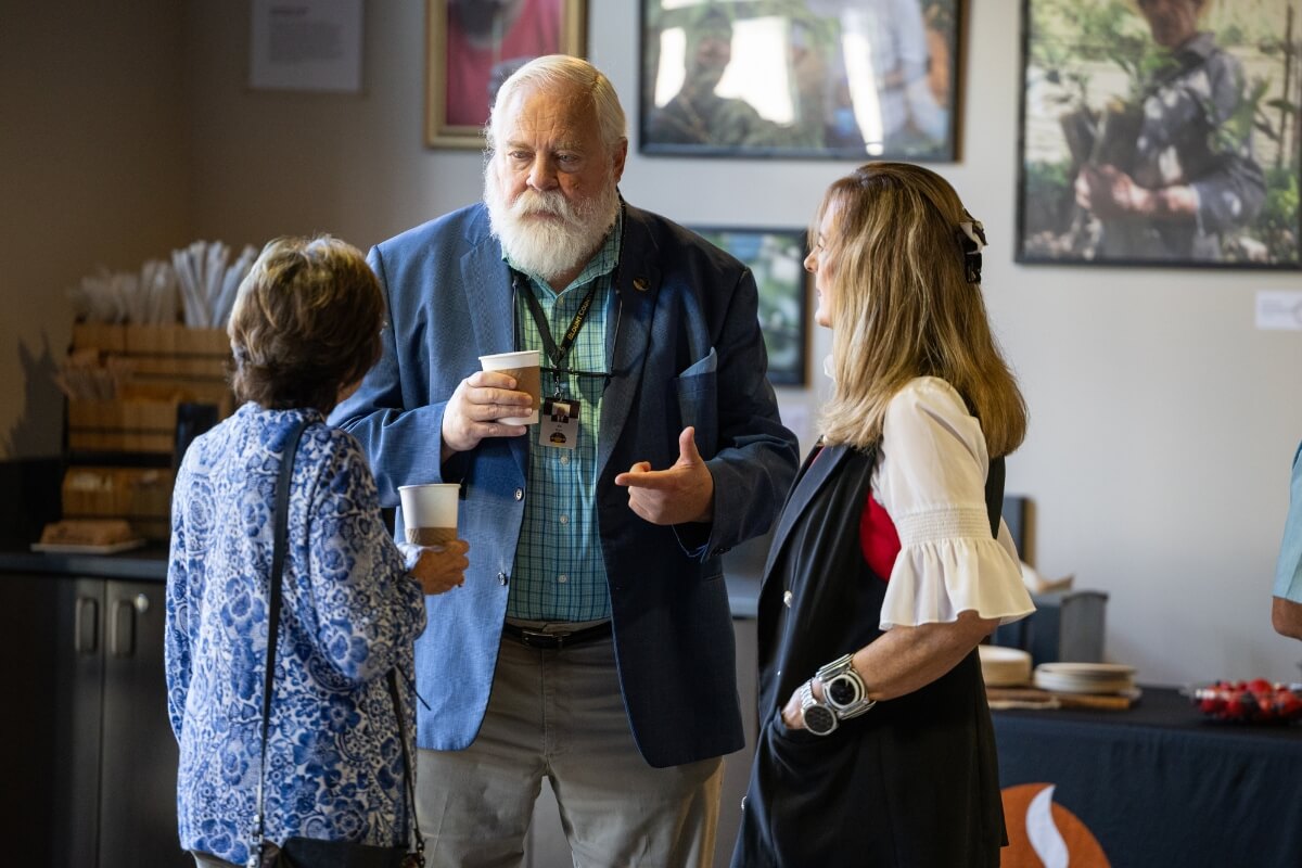 Photo of Blount County Mayor Ed Mitchell talking to two people at the Joy Bishop dedication