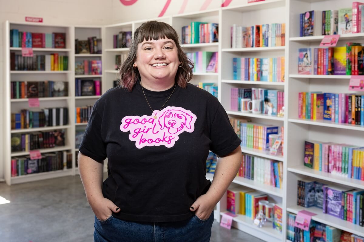 Photo of Dr. Rayanne Streeter smiling, in front of a display of books