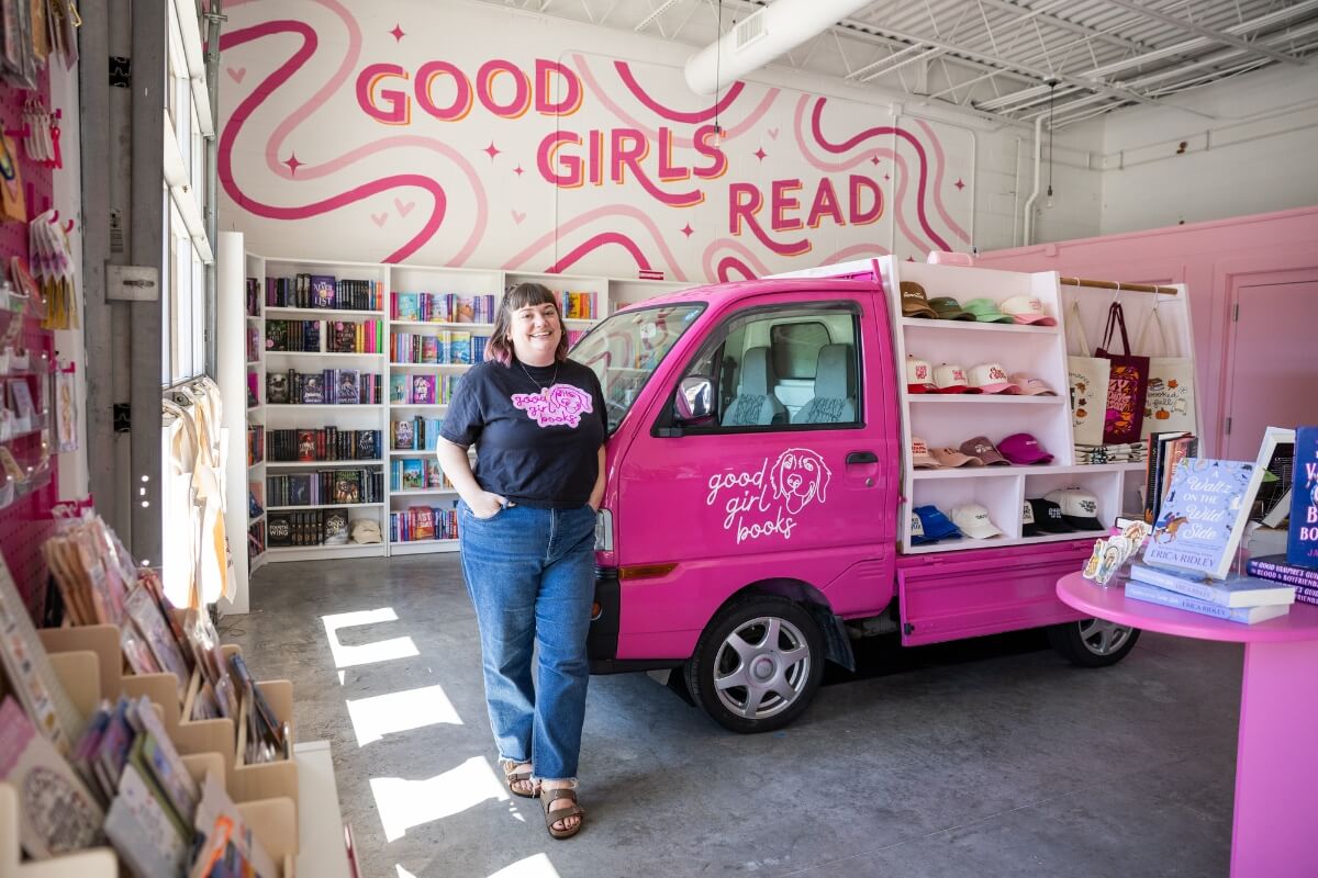 Photo of Dr. Rayanne Streeter standing beside the van that started Good Girl Books.