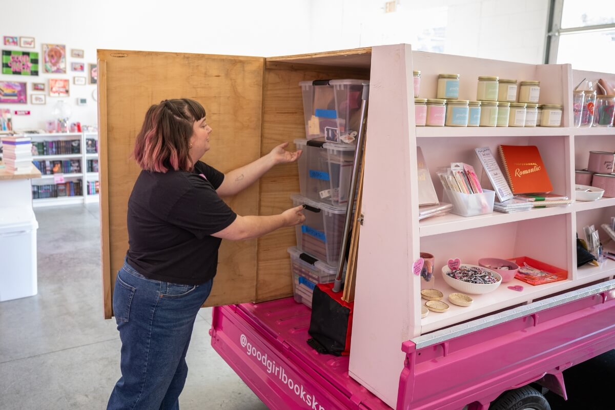 Photo of Dr. Rayanne Streeter of Maryville College opening the storage space of her Mitsubishi Minicab.