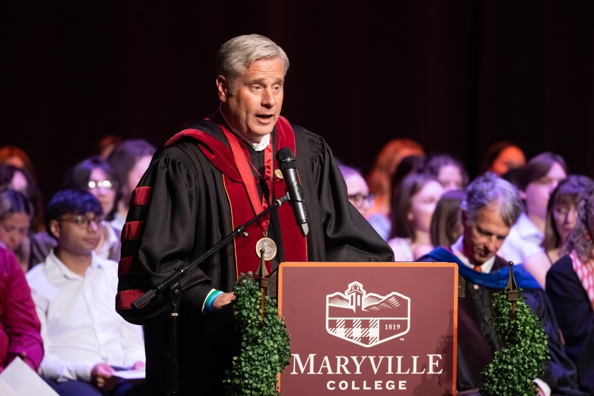 Photo of Dr. Bryan Coker speaking at a podium
