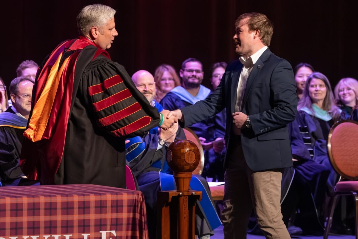 Photo of Dr. Coker congratulating Josh Cornell, named the 2026 Maryville College Outstanding Senior