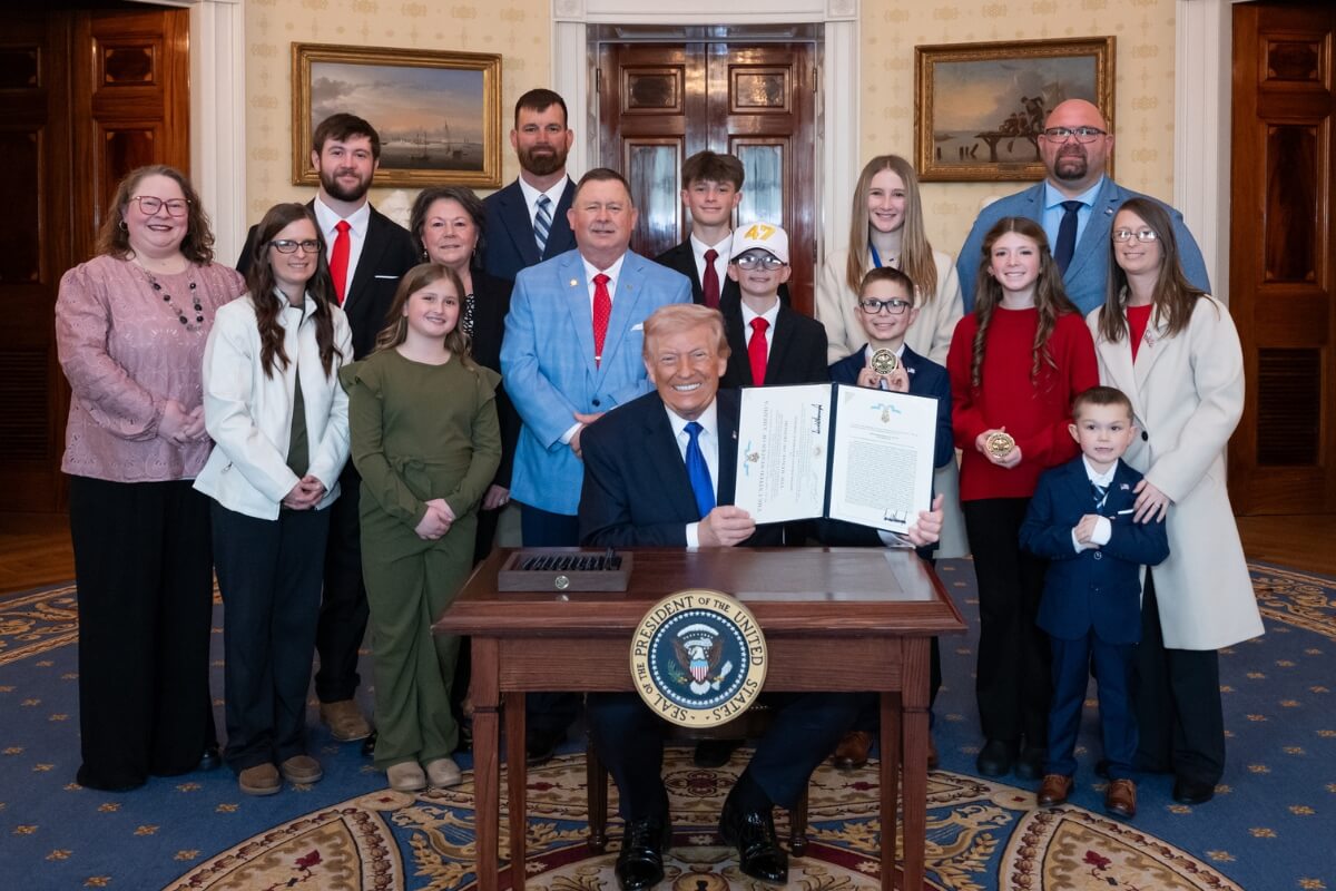 Photo of the Edmonds family surrounding President Donald Trump
