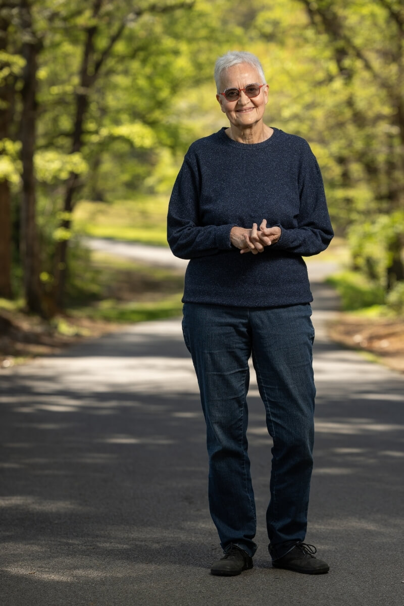 Photo of Jan Taylor in the Maryville College Woods, smiling