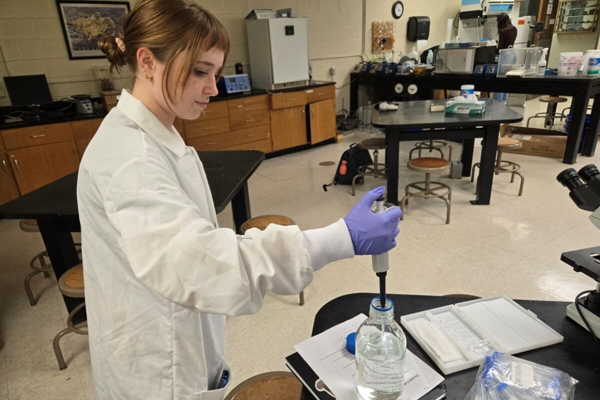 Photo of Aryssa Kelsey in a lab coat