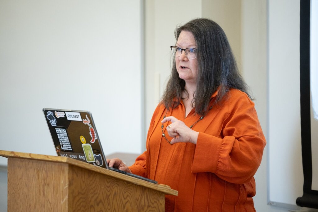 Photo of Nancy Locklin-Sofer lecturing at the front of a class